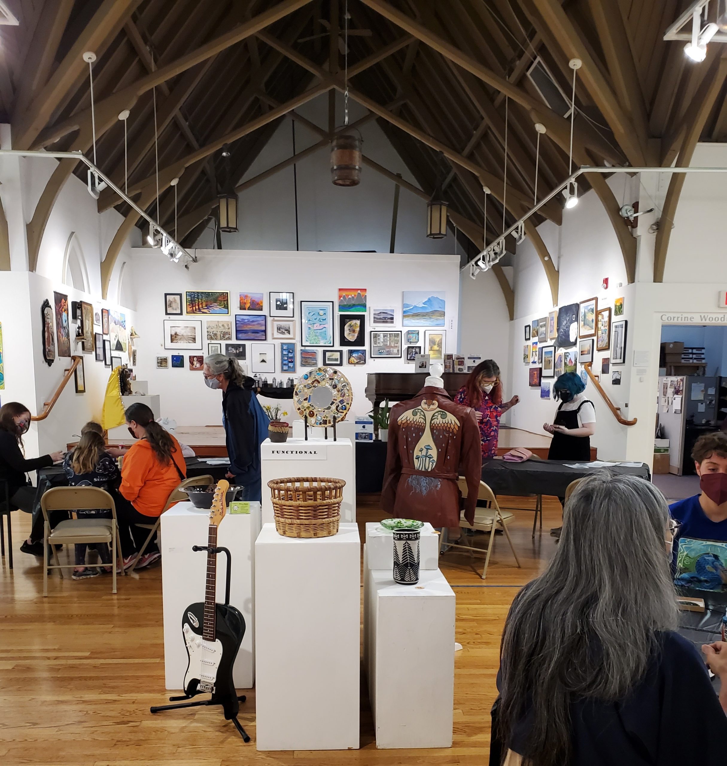 youth and adults making art together in The Arts Center main gallery with tall gothic ceiling