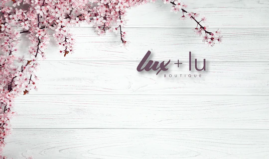 logo for lux & lu boutique is spring pink blossoms with lettering