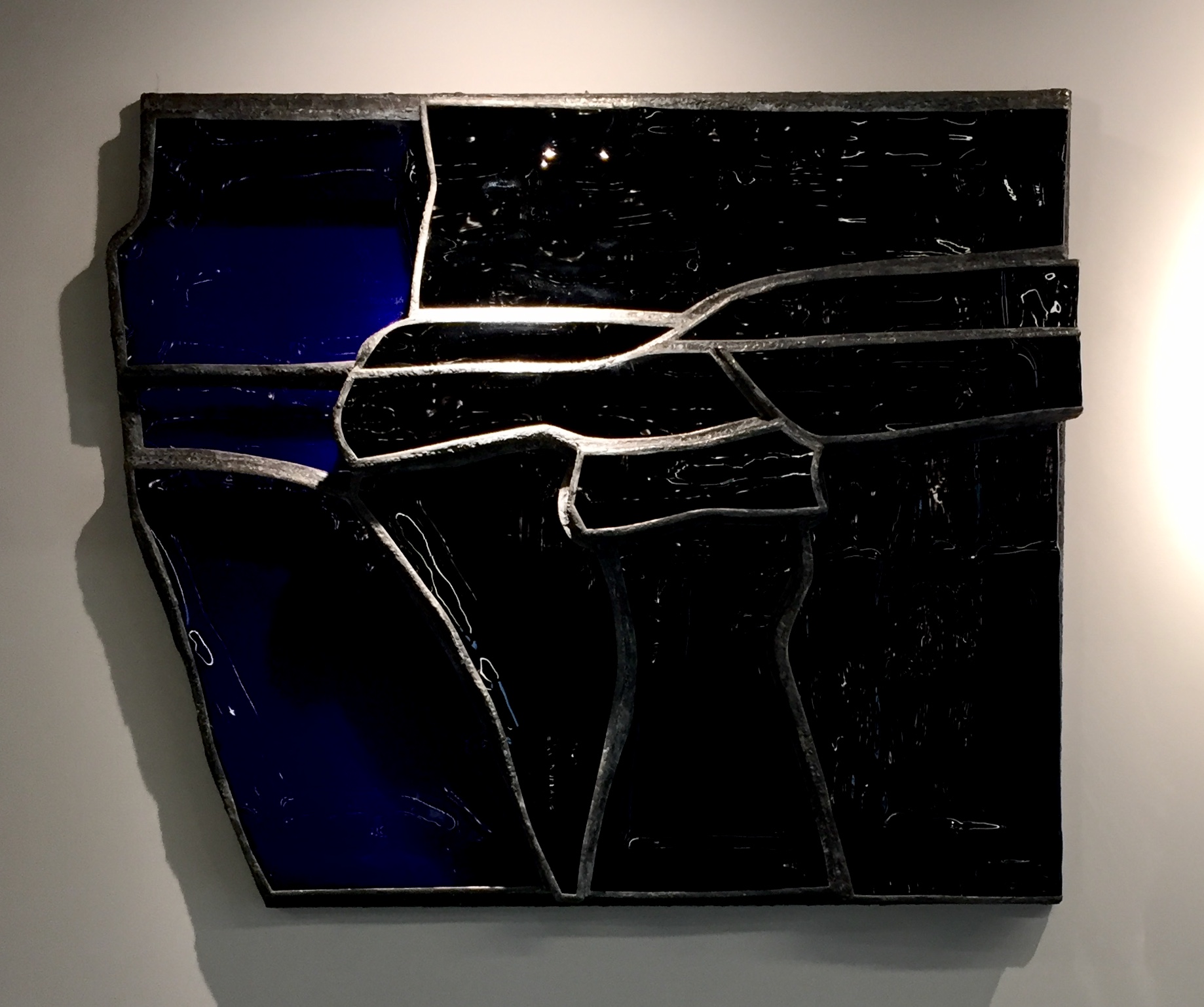 Opaque black and transluscent blue glass and steele wall sculpture