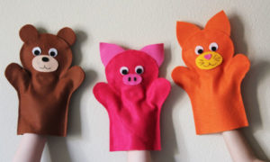 hand puppet of bear-like animals in brown, pink, orange