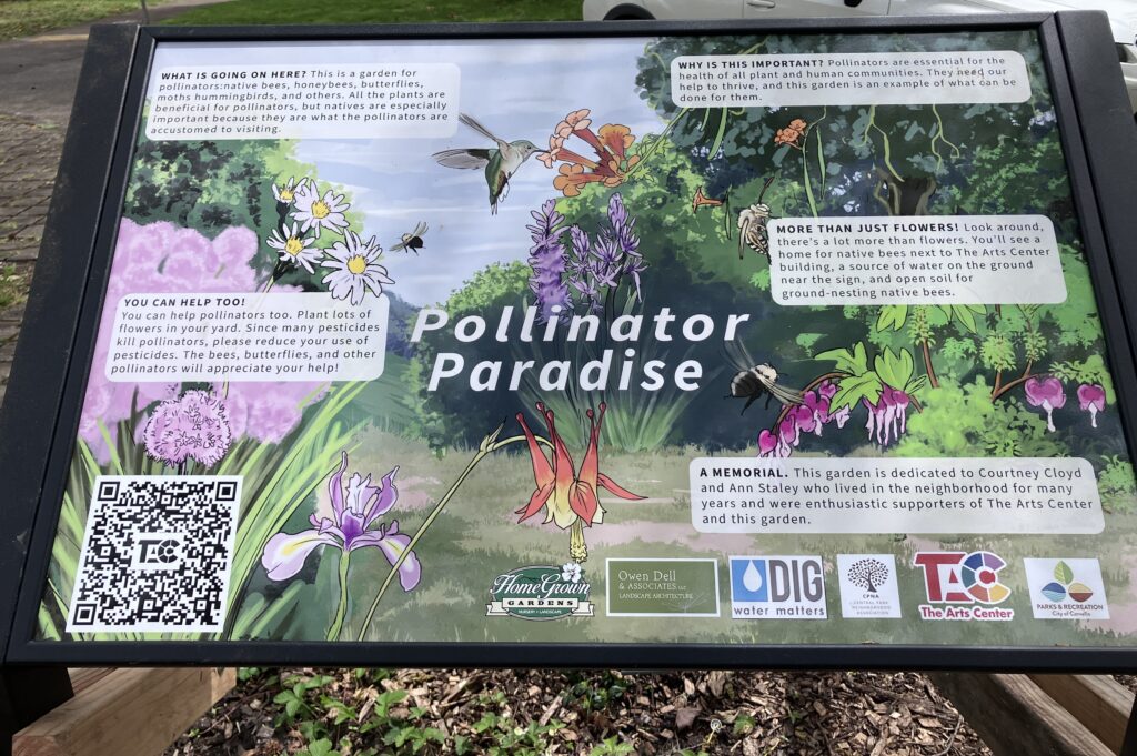 Colorful sign sharing  information about flora and pollinators of the surrounding garden