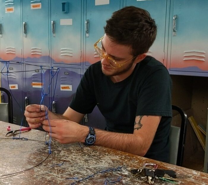 Artist Robin Weis works on a wire scultpure.