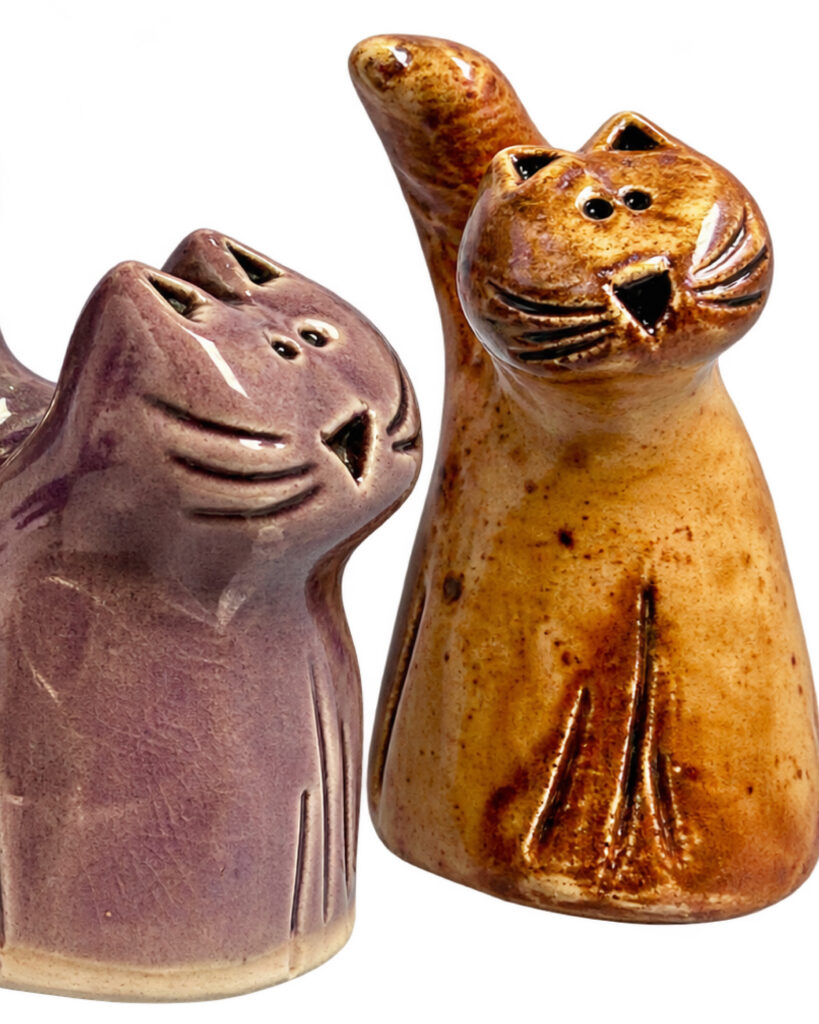 Ceramic cats made by Octobers featured artist Ann Lahr